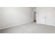 A bright bedroom with gray carpet, closet, and a doorway leading to another room at 187 E Pinckney St, Summerville, SC 29485