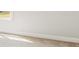 A bedroom wall with white paint and white trim and baseboards and carpeting at 187 E Pinckney St, Summerville, SC 29485