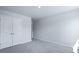 This bedroom features neutral walls, plush gray carpet, and a large closet for storage at 187 E Pinckney St, Summerville, SC 29485