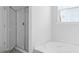 Bathroom featuring glass shower and luxurious soaking tub, creating a spa-like atmosphere at 191 E Pinckney St, Summerville, SC 29485