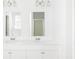 A spacious bathroom with dual sinks, granite countertops, and white cabinets at 191 E Pinckney St, Summerville, SC 29485