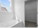Bright bathroom features a tub and closet, offering both relaxation and practical storage at 191 E Pinckney St, Summerville, SC 29485