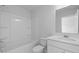 Bright bathroom features a shower-tub combo, white vanity, and undermount sink at 191 E Pinckney St, Summerville, SC 29485