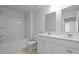 Bathroom showcasing double vanity, well-lit mirrors, and a bathtub-shower combination at 191 E Pinckney St, Summerville, SC 29485