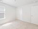 This bedroom features a bright window, plush carpet, white walls, and a closet for your storage needs at 191 E Pinckney St, Summerville, SC 29485