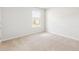 A cozy bedroom features a bright window, plush carpet, and fresh white walls at 191 E Pinckney St, Summerville, SC 29485