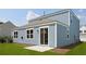 Rear exterior view features a patio and blue siding at 191 E Pinckney St, Summerville, SC 29485