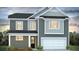 Charming two-story home with an attached two car garage and manicured front yard at 191 E Pinckney St, Summerville, SC 29485