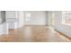 Bright living area with wood floors, white walls, and sliding glass doors to backyard at 191 E Pinckney St, Summerville, SC 29485