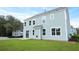 The side and back exterior with lots of large windows and light-blue siding at 199 E Pinckney St, Summerville, SC 29485