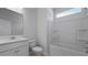 Bathroom featuring a single sink vanity, toilet, and a shower-tub combo with white fixtures at 199 E Pinckney St, Summerville, SC 29485