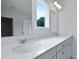 Bathroom featuring a double sink vanity with white countertops, complemented by natural light from a window at 199 E Pinckney St, Summerville, SC 29485