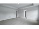 Large bedroom with multiple doors and light grey walls and carpet at 199 E Pinckney St, Summerville, SC 29485