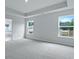 Open bedroom with light walls, grey carpet, and multiple windows at 199 E Pinckney St, Summerville, SC 29485