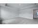 Well-lit bedroom with neutral walls, grey carpet, and tray ceiling at 199 E Pinckney St, Summerville, SC 29485