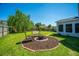 Landscaped backyard featuring a fire pit and a swing at 208 Waterford Ln, Summerville, SC 29483