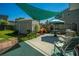 Cozy backyard with patio furniture, shed, privacy fence, and sun shade, perfect for outdoor entertaining at 208 Waterford Ln, Summerville, SC 29483