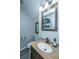 Stylish half bathroom featuring a granite countertop, modern fixtures, and decorative wall art at 208 Waterford Ln, Summerville, SC 29483