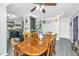 Bright dining area with wooden table, ceiling fan, and open view to a modern kitchen at 208 Waterford Ln, Summerville, SC 29483