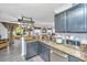 Charming kitchen features granite countertops, gray cabinets, stainless steel appliances, and a pot rack at 208 Waterford Ln, Summerville, SC 29483