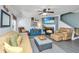 Cozy living room with a fireplace, ceiling fan, comfortable seating, and a view of the backyard at 208 Waterford Ln, Summerville, SC 29483