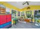 Bright sunroom featuring vaulted ceilings, multiple windows, colorful decor, and a view of the backyard at 208 Waterford Ln, Summerville, SC 29483