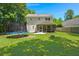 Expansive backyard with a trampoline, fire pit, lush greenery, and a covered patio area for outdoor enjoyment at 214 Blackstone Dr, Moncks Corner, SC 29461