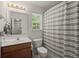 Bright bathroom featuring a vanity with a light fixture and a shower/tub combination with gray and white striped curtain at 214 Blackstone Dr, Moncks Corner, SC 29461