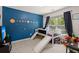bedroom featuring blue walls, a custom bed with slides, and a large window for natural light at 214 Blackstone Dr, Moncks Corner, SC 29461