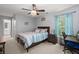 Relaxing bedroom with a ceiling fan, natural light, and calming blue accents at 214 Blackstone Dr, Moncks Corner, SC 29461