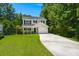 Charming two-story home features a long driveway, one car garage and well-maintained lawn surrounded by mature trees at 214 Blackstone Dr, Moncks Corner, SC 29461