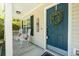 Inviting front porch with rocking chairs and a teal front door adorned with a wreath, exuding a welcoming atmosphere at 214 Blackstone Dr, Moncks Corner, SC 29461