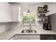 Bright kitchen features granite countertops, stainless steel sink, and open shelving at 214 Blackstone Dr, Moncks Corner, SC 29461