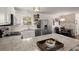 Bright kitchen with white cabinets, stainless steel appliances, granite counters, and seamless connection to the dining area at 214 Blackstone Dr, Moncks Corner, SC 29461