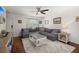 Well-lit living room featuring a plush gray sectional sofa, complemented by a stylish coffee table and neutral rug at 214 Blackstone Dr, Moncks Corner, SC 29461