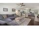 Bright living room featuring a gray sectional sofa, a decorative coffee table and seamless transition to the kitchen at 214 Blackstone Dr, Moncks Corner, SC 29461