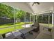 Relaxing screened-in patio featuring comfortable seating, a ceiling fan, and a view of the backyard at 214 Blackstone Dr, Moncks Corner, SC 29461