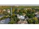Beautiful elevated home surrounded by mature trees with a glimpse of the ocean in the distance at 2213 Rolling Dune Rd, Seabrook Island, SC 29455