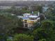 Beautiful multi-story home nestled among trees, featuring multiple balconies and rooftop deck at 2213 Rolling Dune Rd, Seabrook Island, SC 29455
