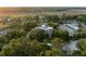 An aerial view shows lush greenery, trees, and lovely homes, with a pool nearby at 2213 Rolling Dune Rd, Seabrook Island, SC 29455
