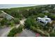 Beautiful elevated home with a rooftop terrace is surrounded by lush green trees and neighborhood charm at 2213 Rolling Dune Rd, Seabrook Island, SC 29455