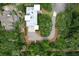 Beautiful elevated home with a rooftop deck, manicured landscaping, and private driveway is surrounded by trees at 2213 Rolling Dune Rd, Seabrook Island, SC 29455