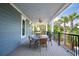 Enjoy outdoor dining on this spacious back porch with a table and seating at 2213 Rolling Dune Rd, Seabrook Island, SC 29455