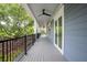 Expansive back porch with seating and views of the surrounding greenery at 2213 Rolling Dune Rd, Seabrook Island, SC 29455