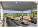 This spacious covered porch has comfortable outdoor seating to enjoy the fresh air and greenery at 2213 Rolling Dune Rd, Seabrook Island, SC 29455