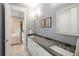 Modern bathroom with double vanity, stone countertops, and elegant fixtures, adjacent to the main bedroom at 2213 Rolling Dune Rd, Seabrook Island, SC 29455