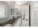 Elegant bathroom featuring double sinks, stone countertops, and a view into the light-filled bedroom suite at 2213 Rolling Dune Rd, Seabrook Island, SC 29455