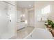 Bright bathroom featuring a soaking tub, walk-in shower, and bright marble vanity at 2213 Rolling Dune Rd, Seabrook Island, SC 29455