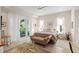 Bedroom with walk out balcony, neutral color palette, hardwood floors, and french doors at 2213 Rolling Dune Rd, Seabrook Island, SC 29455