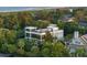 Beautifully landscaped home with multiple levels and large windows, nestled amongst lush greenery at 2213 Rolling Dune Rd, Seabrook Island, SC 29455